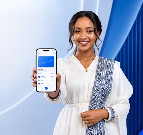 Smiling Ethiopian woman holding an iPhone that displays the Biloo Mezgeb mobile business application